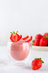 Tofu soy dessert with strawberry in a glass. Lactose and sugar free. Vertical orientation.