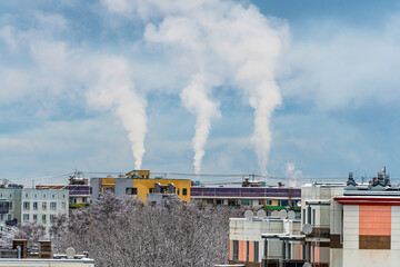 Smoke from the chimneys of the factory on the background of the city