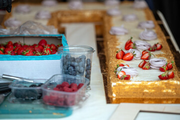 Cake decorating with berries. Shallow depth of feld