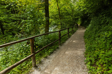 Vintgar Gorges Park a few km from Lake Bled, Slovenia. Wooden walkways accompany the path above the river rapids and waterfalls. River hits rocks and creates fog.Adventure family holidays. Freshness.