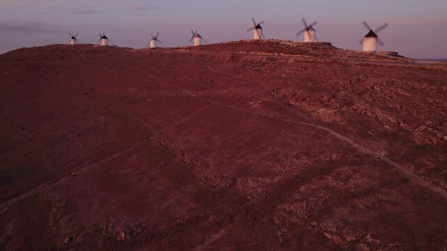 Aerial view of traditional windmills at sunrise with Castillo, Consuegra, Toledo, Spain.