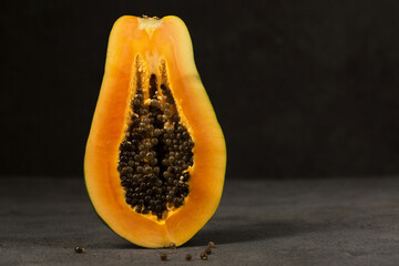 Half a papaya stands directly on the background