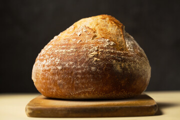Delicious homemade unleavened round bread in the shape of a volcano on a wooden board