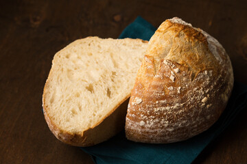 Delicious bread in the shape of a volcano cut in half. Still life in a rustic style