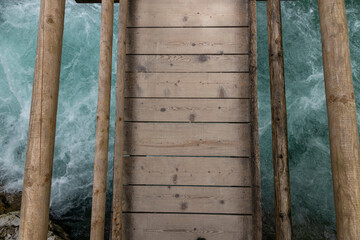 Vintgar Gorges Park a few km from Lake Bled, Slovenia. Wooden walkways accompany the path above the river rapids and waterfalls. River hits rocks and creates fog.Adventure family holidays. Freshness.