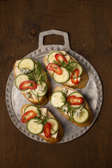 Сheese and cucumber baguette canapes, top view