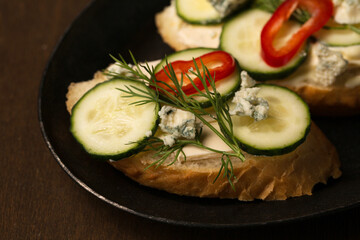 Сheese and cucumber baguette canapes, close-up