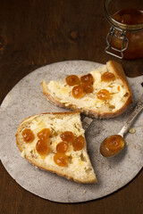 Homemade bread, butter and yellow cherry jam, close-up