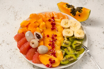 A large plate with fruits on a light background