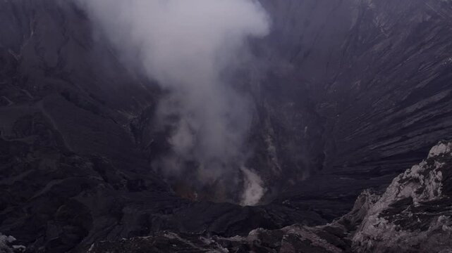 Aerial view of smoking volcano summit and crater, Bromo, East Java, Indonesia.