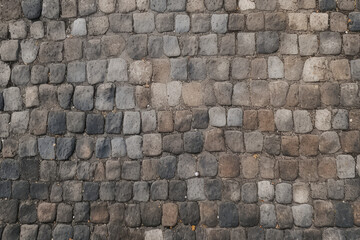 Naklejka premium Processed collage of old european cobble stone pavement texture. Background for banner