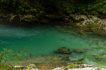 Vintgar Gorges Park a few km from Lake Bled, Slovenia. Wooden walkways accompany the path above the river rapids and waterfalls. River hits rocks and creates fog.Adventure family holidays. Freshness.
