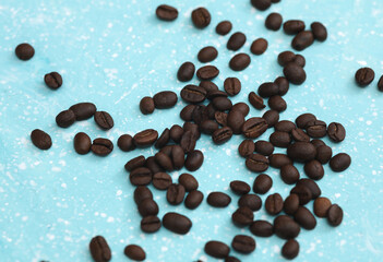 Coffee beans on blue concrete background