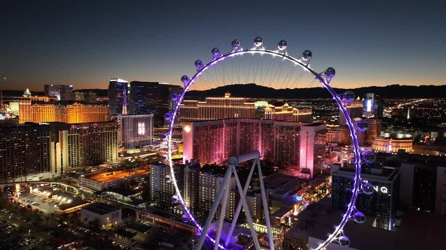 Ferris Wheel At Las Vegas Nevada United States. Aerial View Of A High-Rise Buildings And Traffic In Las Vegas City. Sunset Sky Background Downtown Cityscape. Sunset Drone View Panoramic.