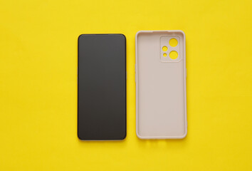 Protective case with smartphone on yellow background
