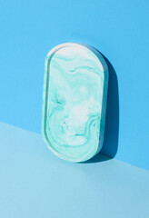 Plaster oval tray on blue background