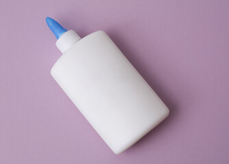 Bottle of pva glue on purple background
