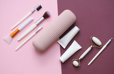 Organizer case with makeup accessories on a pink burgundy background