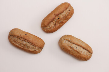 Appetizing rye buns on a beige background