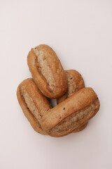 Appetizing rye buns on a beige background