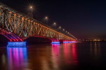 Bridge of the Legions of Josef Pilsudski at night with colorful lighting. Plock, Poland