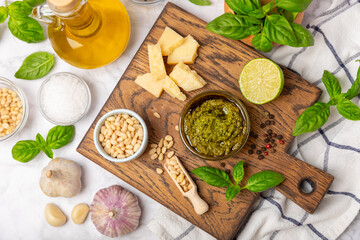 Pesto. Italian basil pesto sauce on a textured wooden background. Ingredient for pesto sauce: fresh...