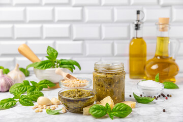 Pesto. Italian basil pesto sauce on a textured wooden background. Ingredient for pesto sauce: fresh...