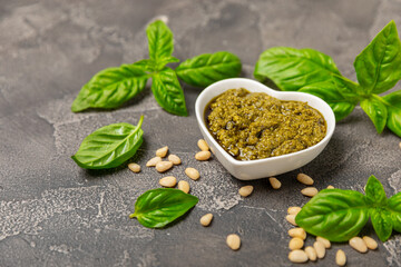 Pesto. Italian basil pesto sauce on a textured wooden background. Ingredient for pesto sauce: fresh...