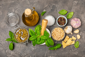 Pesto. Italian basil pesto sauce on a textured wooden background. Ingredient for pesto sauce: fresh...