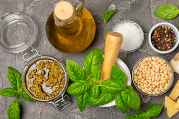 Pesto. Italian basil pesto sauce on a textured wooden background. Ingredient for pesto sauce: fresh...