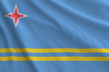 Aruba flag depicted on folded wavy fabric of old cloth close up
