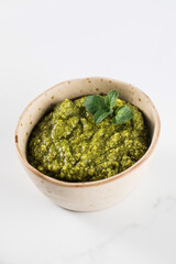 Fresh homemade pesto sauce in a bowl. Italian cuisine. Recipe.