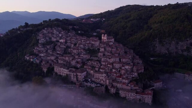 Aerial view of foggy Santo Stefano church on hill in Artena, Rome, Italy.