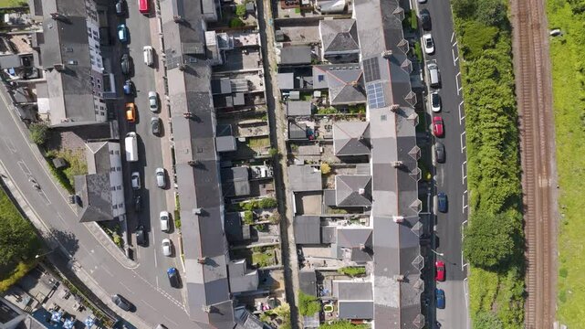 Aerial view of residential terraced houses with back gardens and alleyway in Plymouth, UK