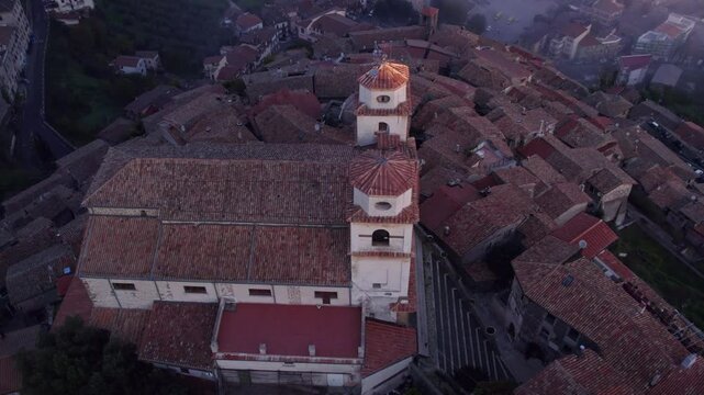 Aerial view of Santo Stefano church in foggy morning, Artena, Italy.