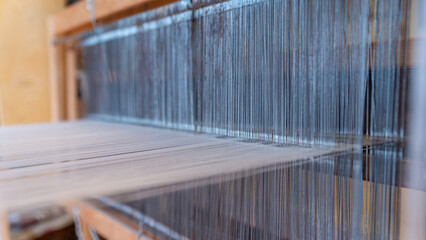 Weaving, traditional crafts,Close-up of a loom weaving, Woven silk,using cotton and silk string...