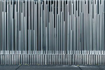Fototapeta premium Scene of industrial design and urban architecture, featuring a metal bar fence with vertical line