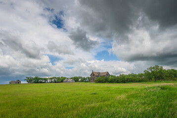 Abandoned house and farm buildings on the prairie near Lajord, Saskatchewan, Canada