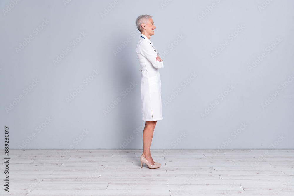 Sticker full size side profile photo of cheerful woman wear white uniform stethoscope on neck hold arms fold