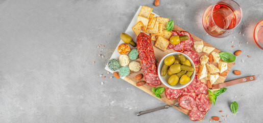 Antipasto board with rose wine. italian antipasto platter of salami slices