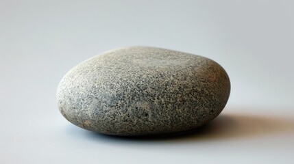 A round stone that is smooth and gray