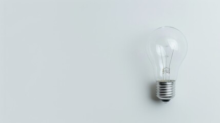Iconic light bulb resting on a clean white surface symbolizing simplicity and minimalistic concepts