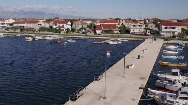 Aerial view of picturesque harbour town with boats, houses, and calm water, Nin, Croatia.
