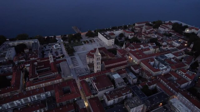 Aerial view of historic town at sunrise with boat-filled harbour, Zadar, Croatia.