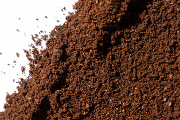Scattered ground natural coffee on white background