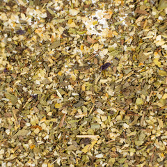 Herb blend seasoning of oregano, basil, onion, garlic and thyme, macro, top view.