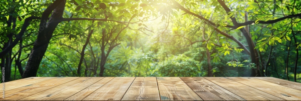 Poster a blurred green tree in the park garden background and an empty wood table top - copy space for disp