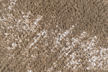 Abstract brown ground black pepper background top view. Creativity in cooking.