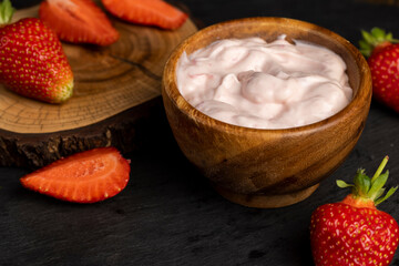 yogurt made from milk with added flavor and pieces of ripe strawberries