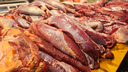 A Variety of freshly butchered beef cuts displayed at a local market stall